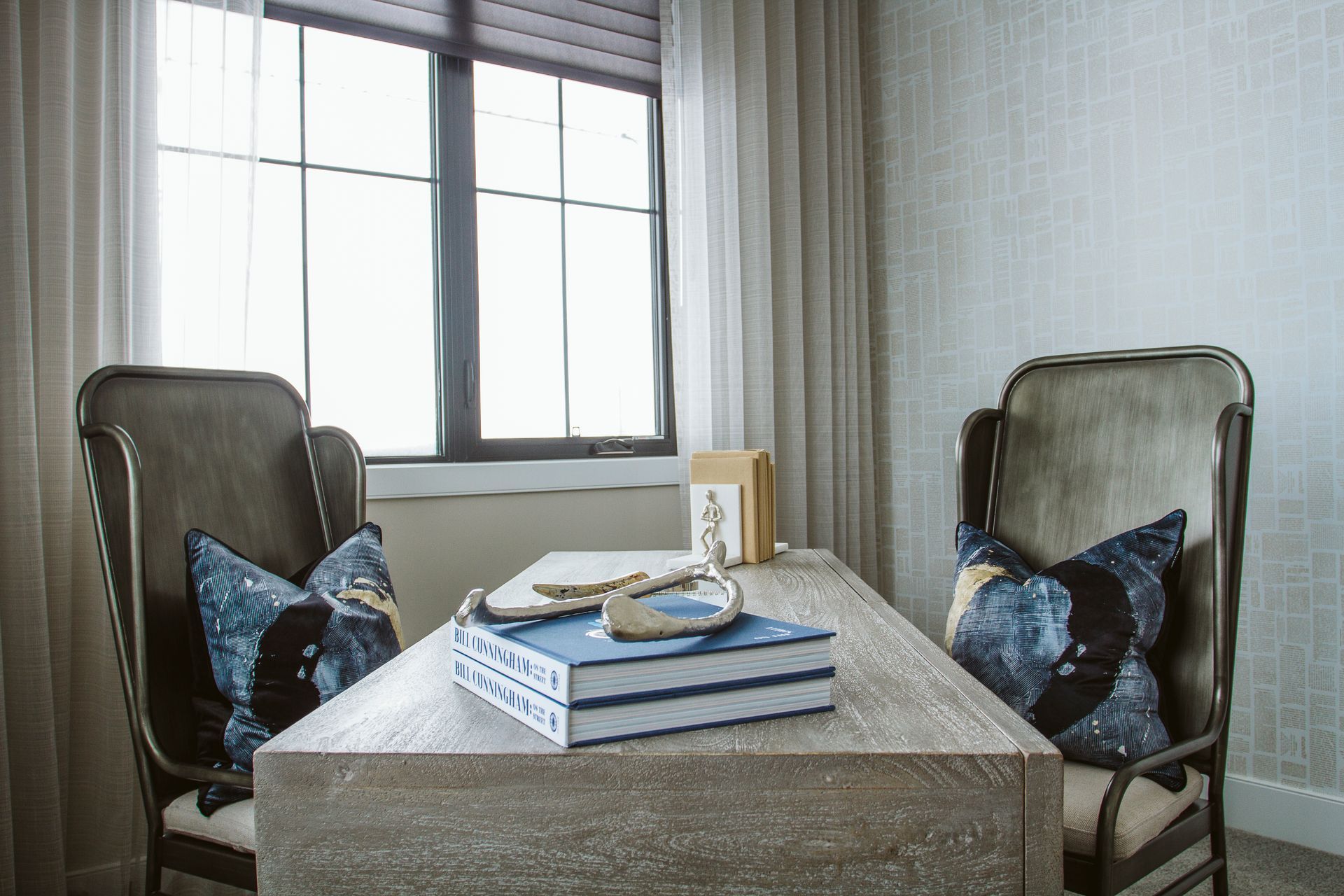 There are two chairs and a desk in the room.