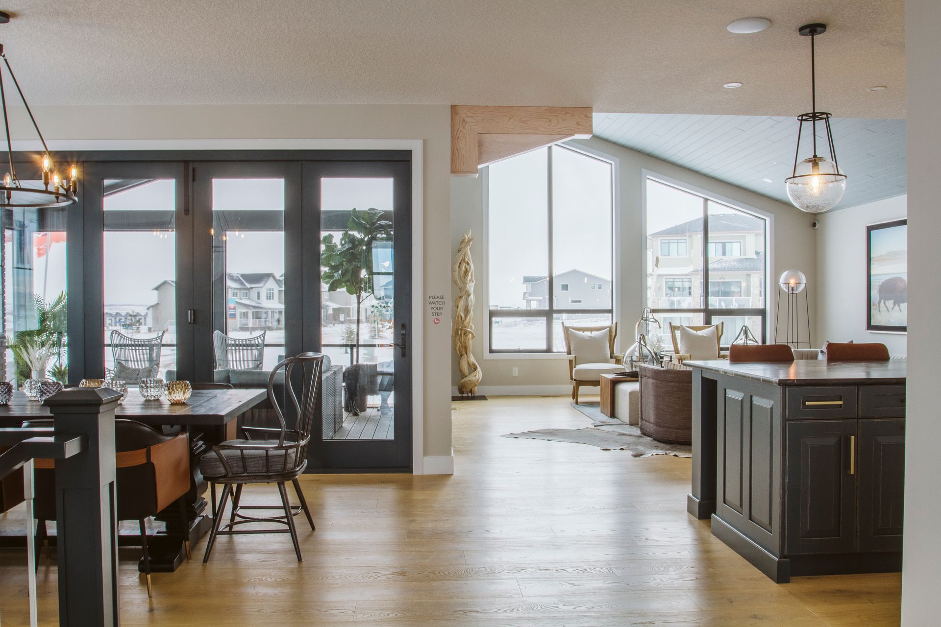 A living room with a table and chairs and a kitchen