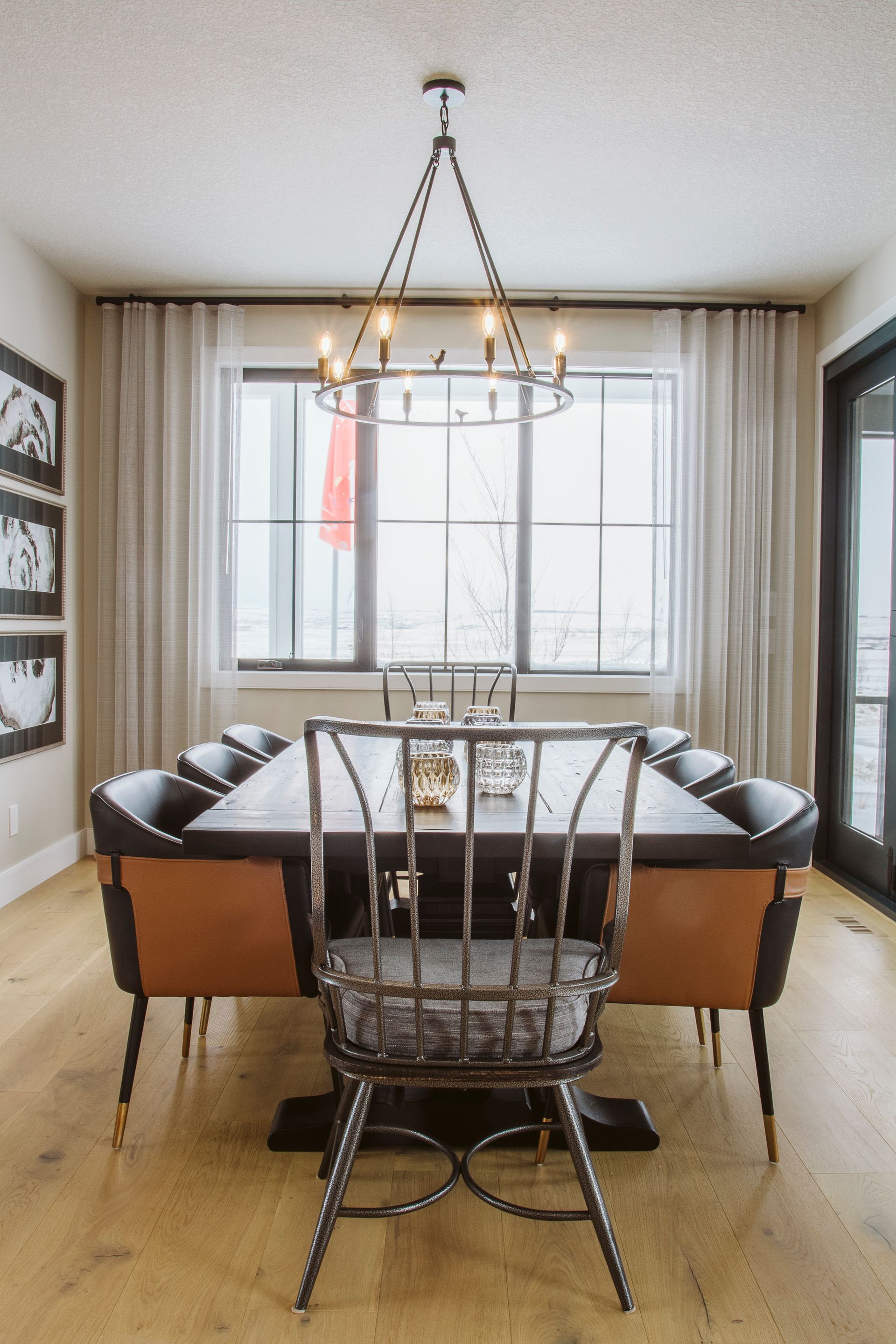 A dining room with a table and chairs and a chandelier
