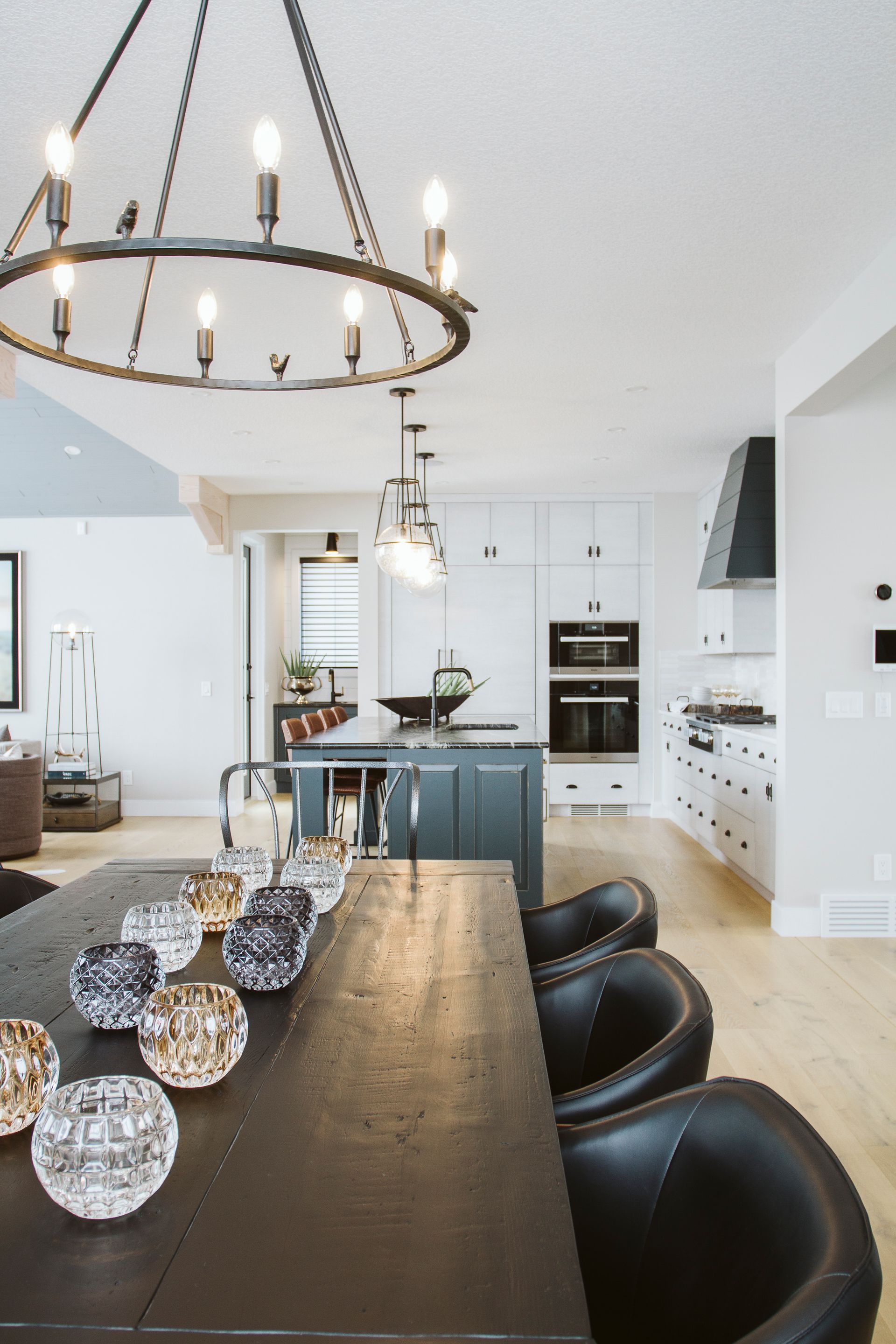 A kitchen with a table and chairs and a chandelier hanging from the ceiling.