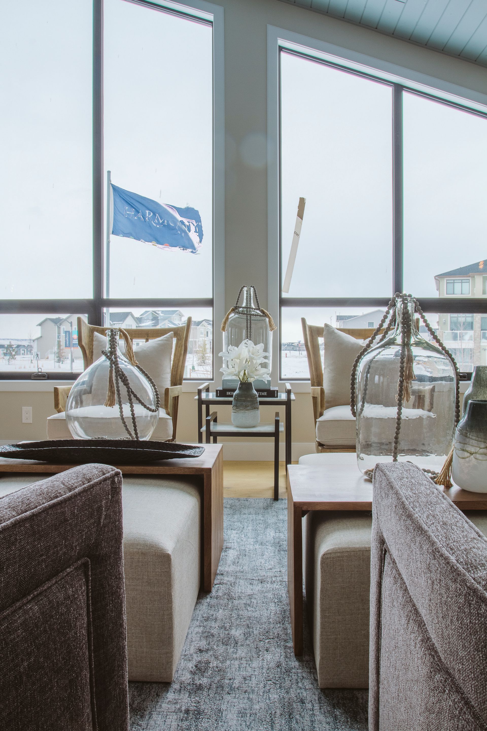 A living room with a lot of furniture and a large window.