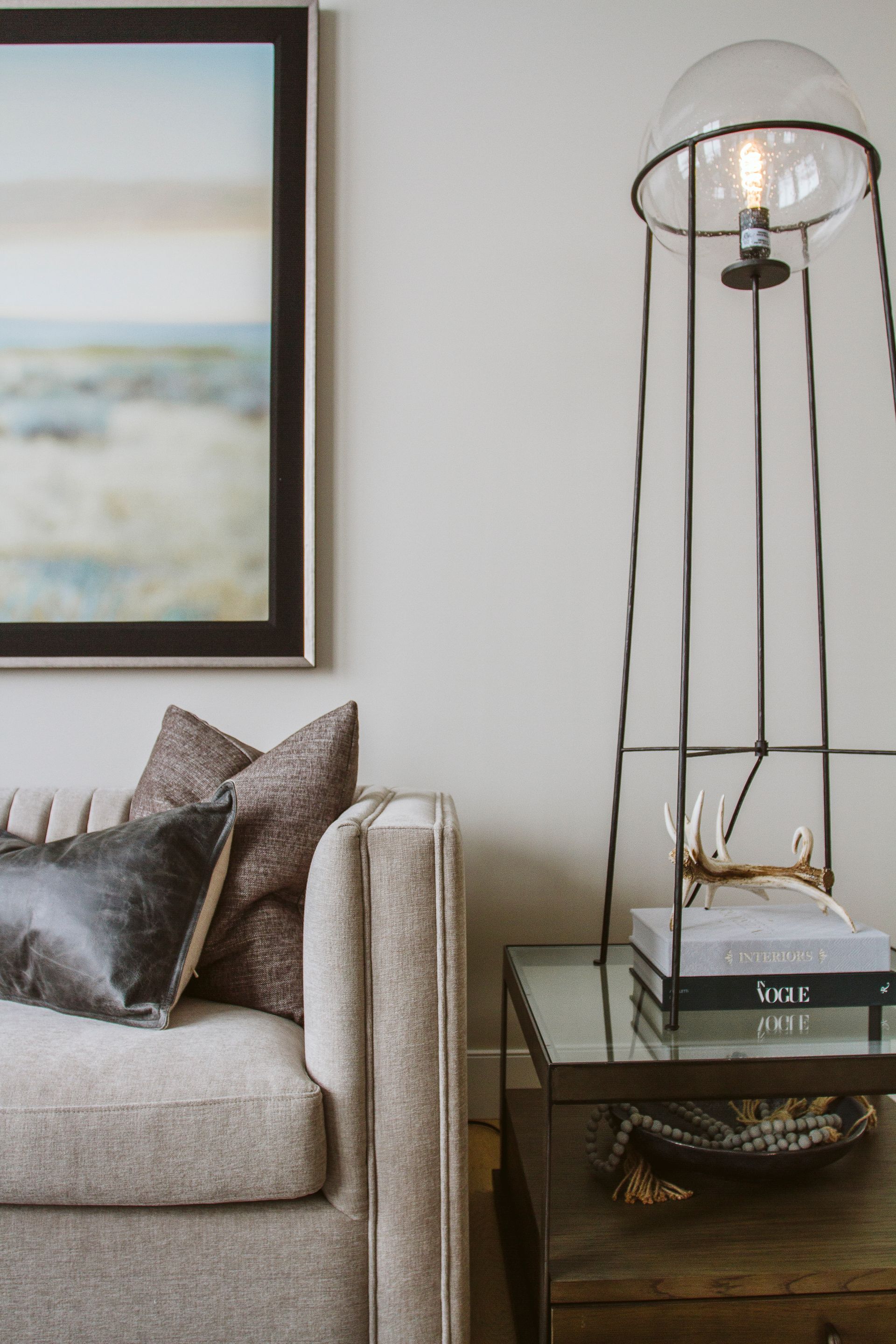A living room with a couch and a lamp