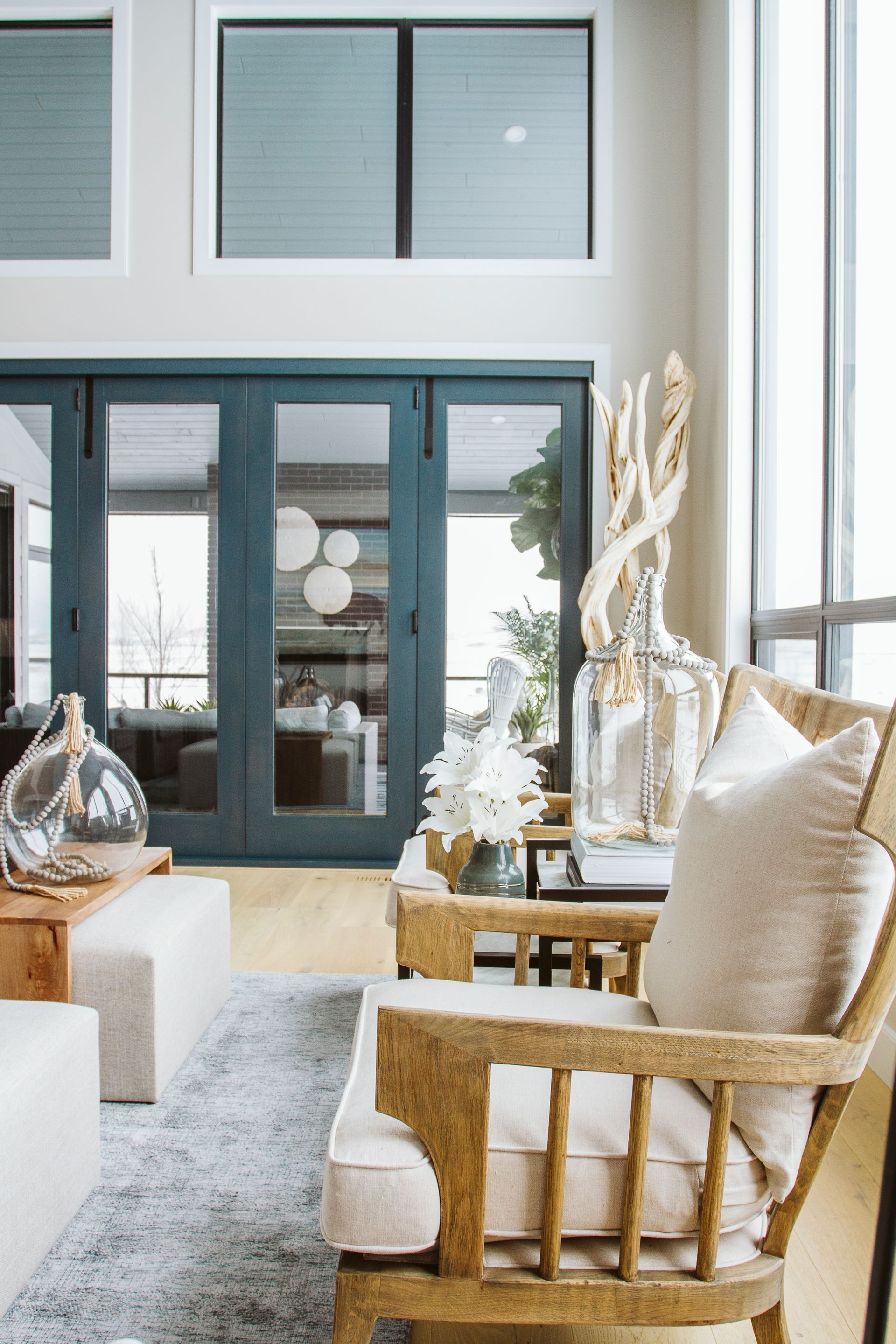 A living room with a wooden chair and a couch.