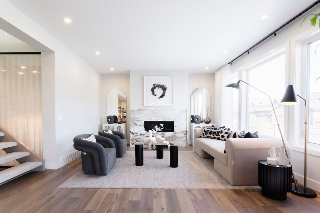 A living room with a couch and chairs and a fireplace