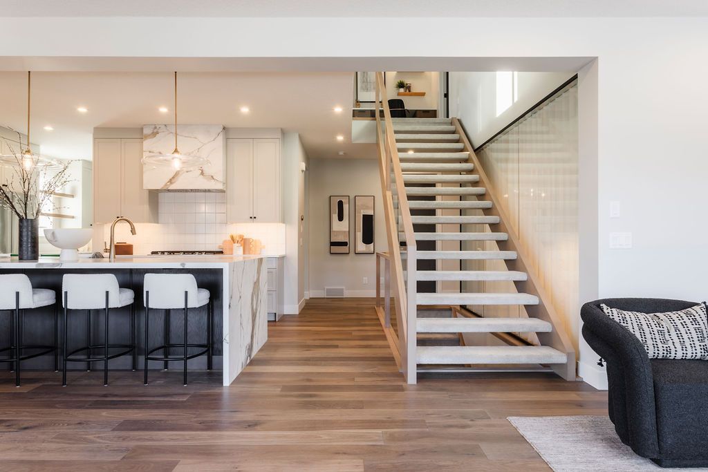 A living room with a staircase leading up to the second floor