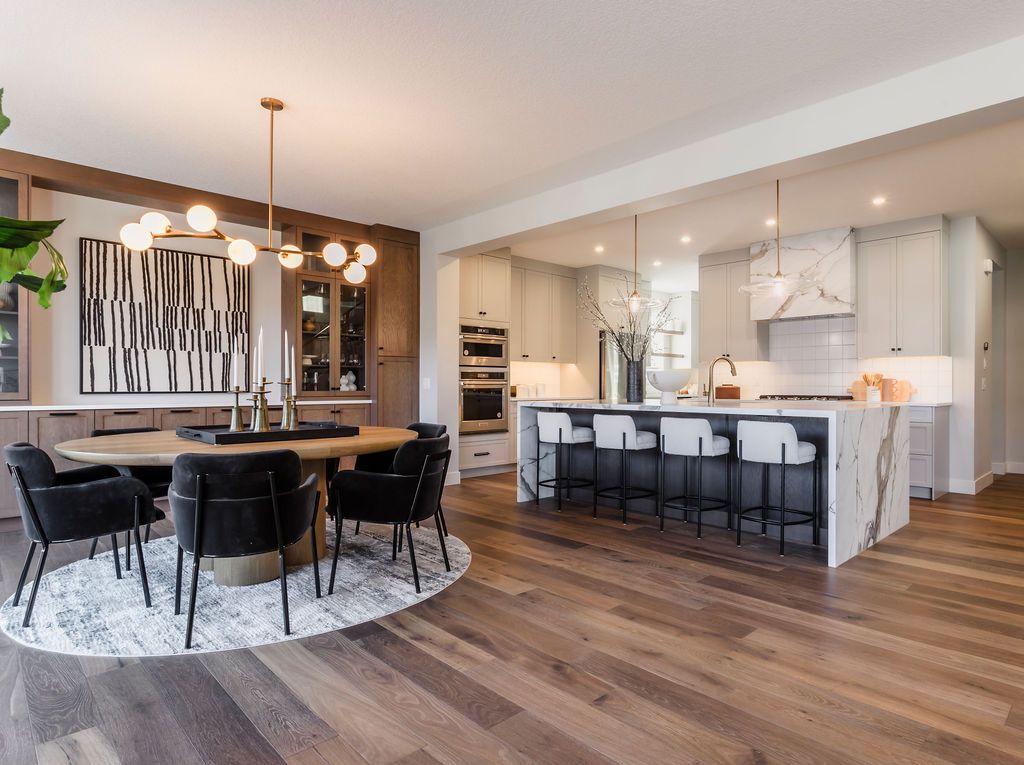 A kitchen and dining room in a house with hardwood floors