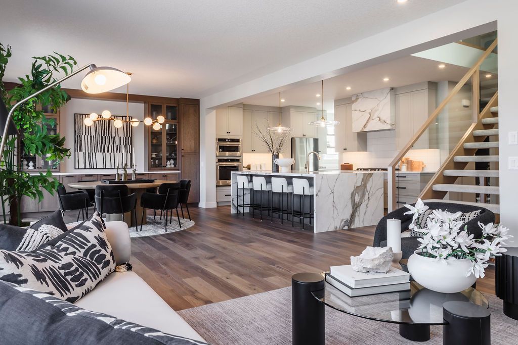 A living room with a couch , chair , coffee table and stairs
