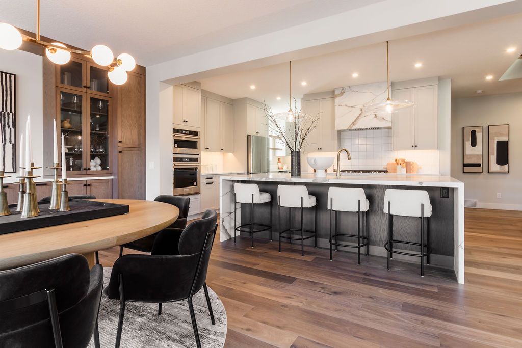 A kitchen and dining room in a house with a table and chairs.