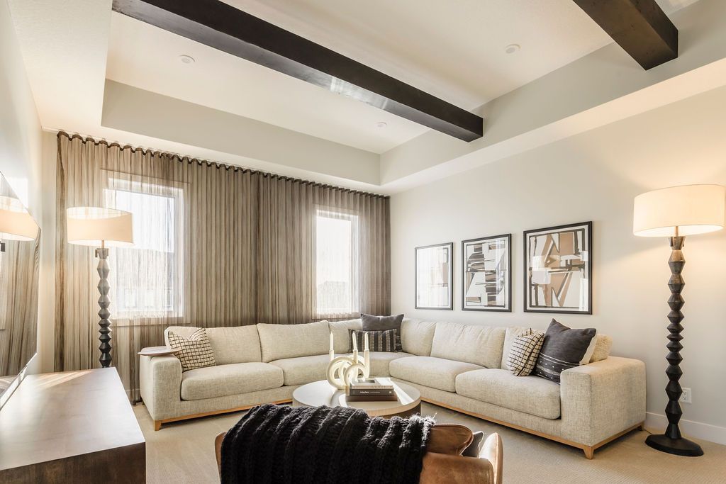 A living room with a large sectional couch and a coffee table