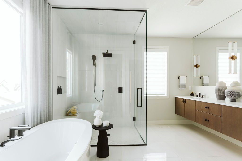 A bathroom with a bathtub and a walk in shower.