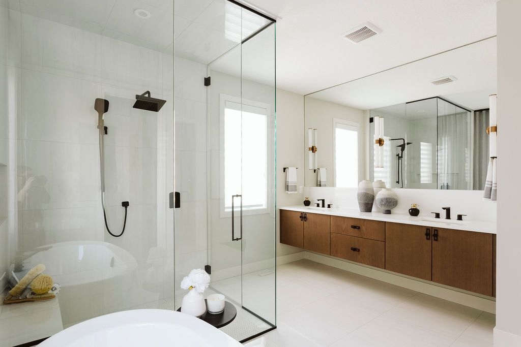 A bathroom with a tub , sinks , shower and mirror.