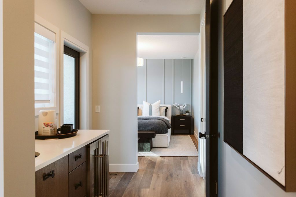 A hallway in a house leading to a bedroom.