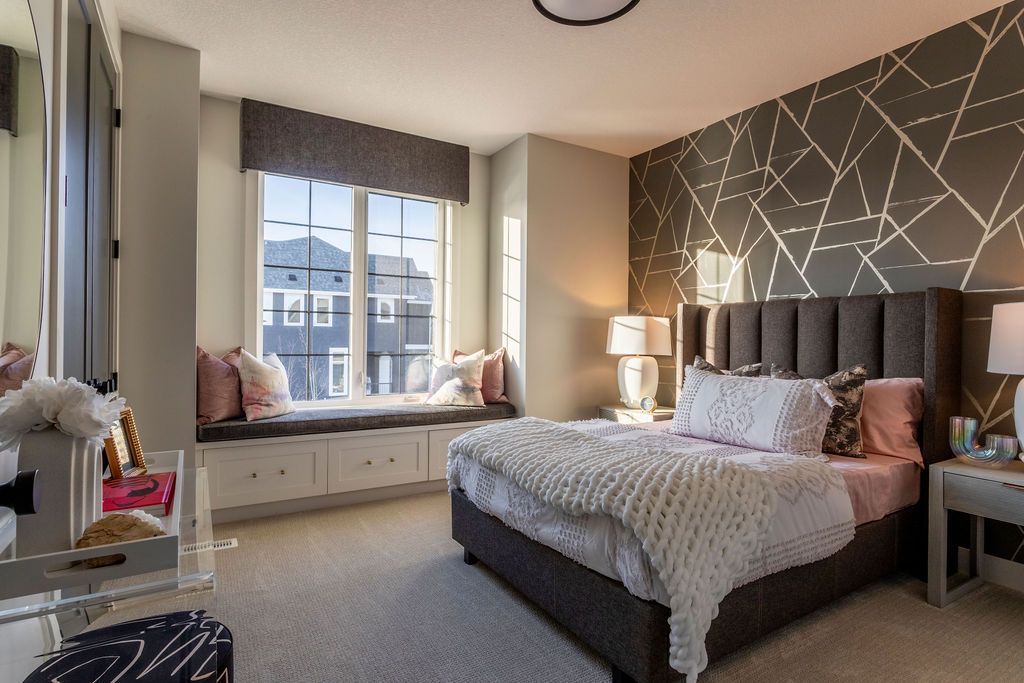 A bedroom with a large bed and a window seat.