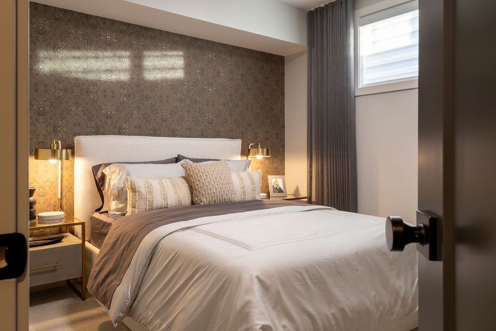 A bedroom with a large bed and a window.