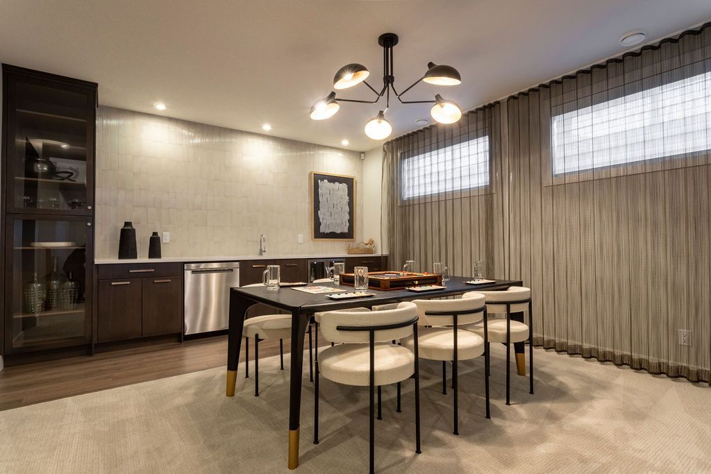 A dining room with a table and chairs in a basement.