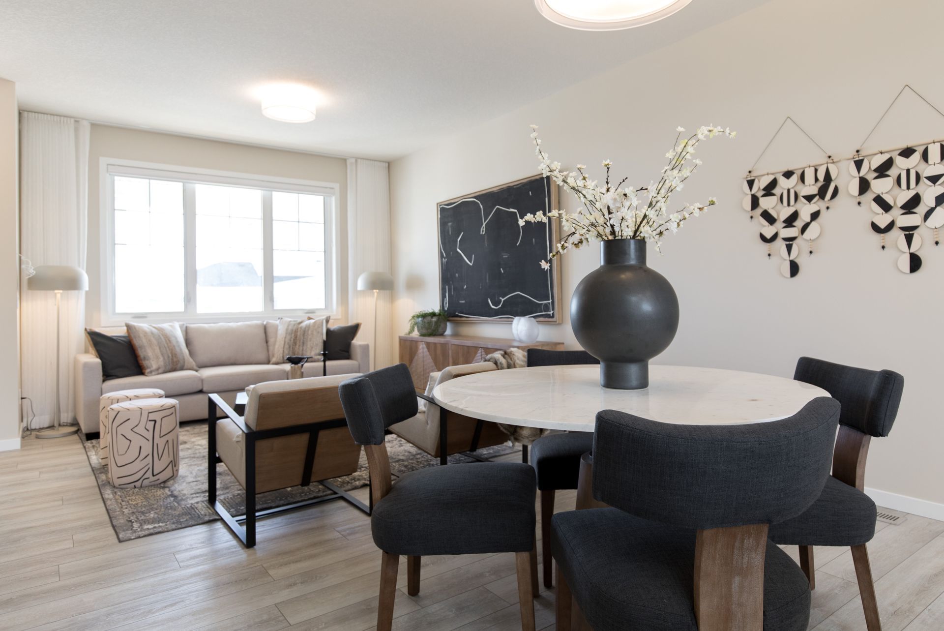 A living room with a table and chairs and a couch.