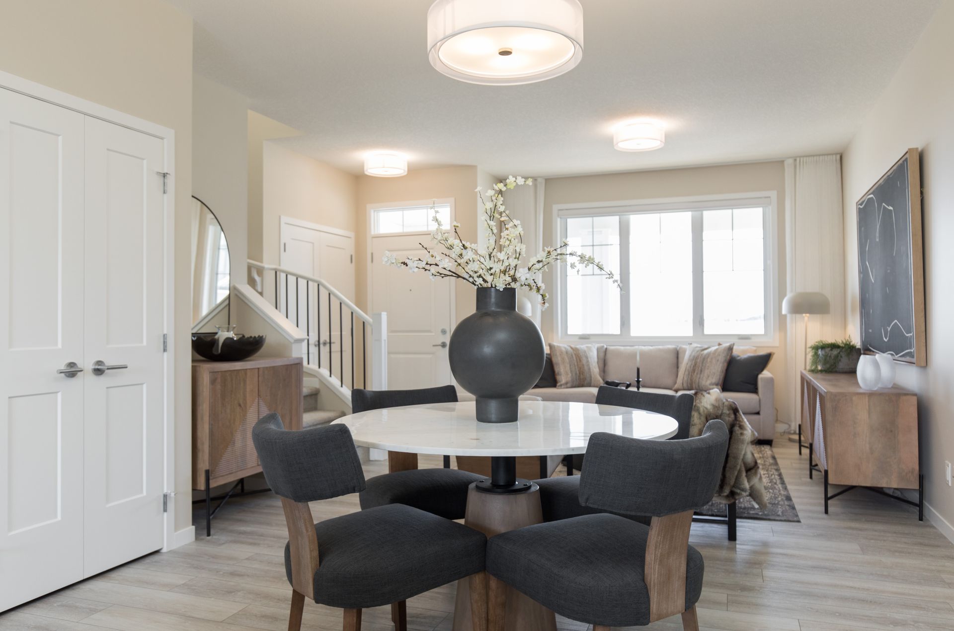 There is a table and chairs in the middle of the room.