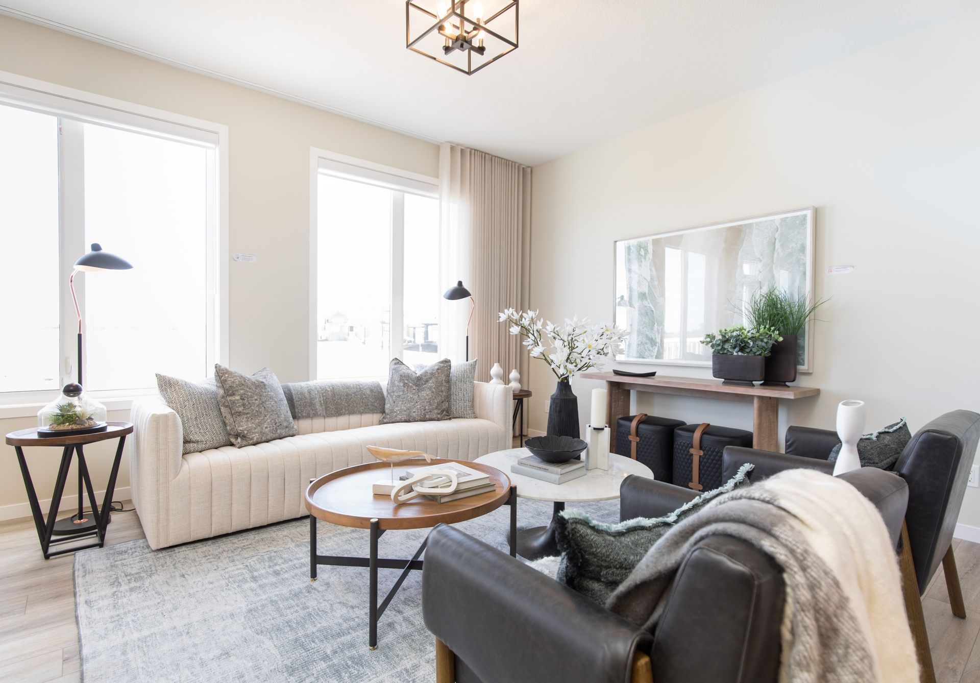 A living room with a couch , chairs , and a coffee table.