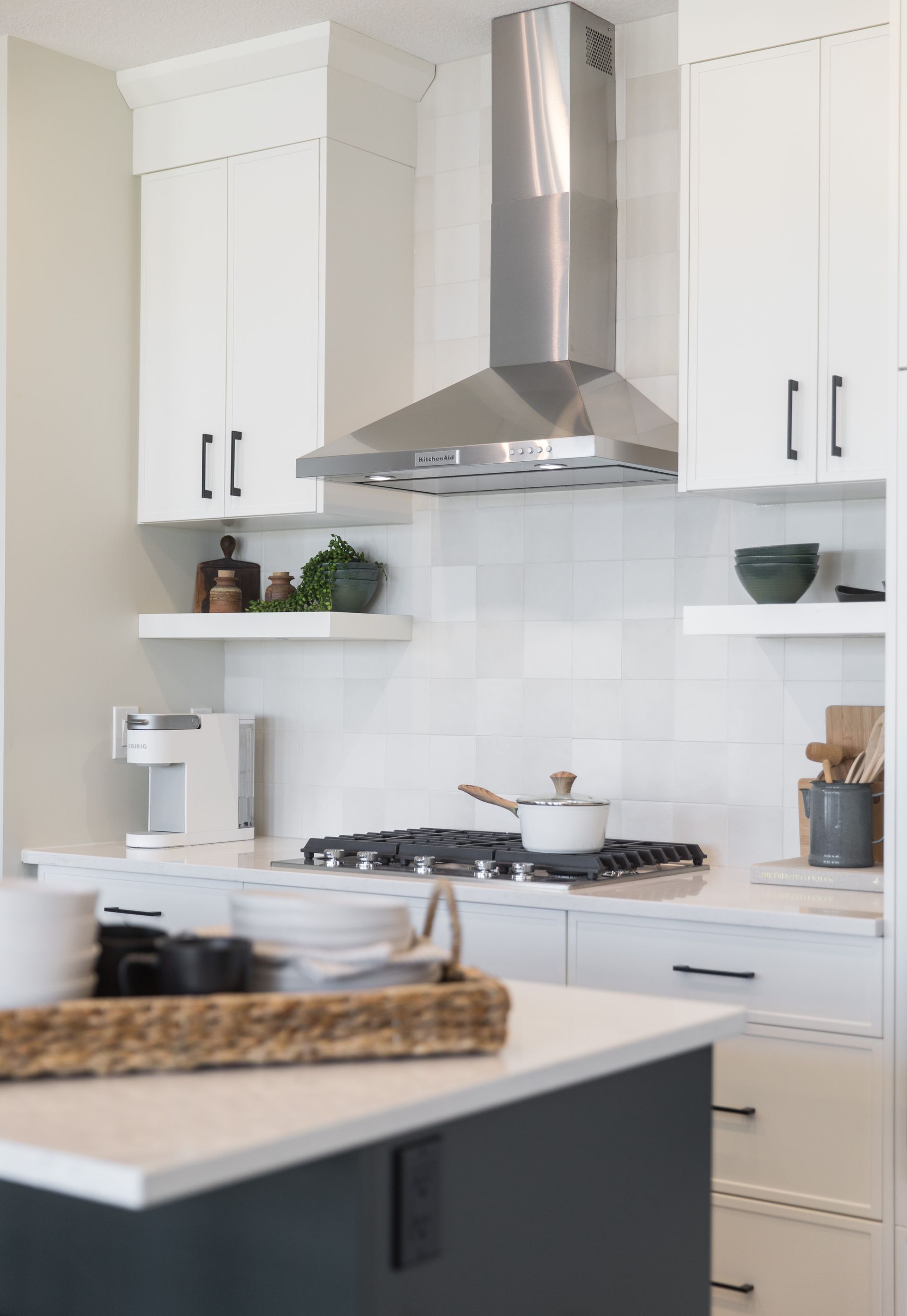A kitchen with white cabinets and stainless steel appliances