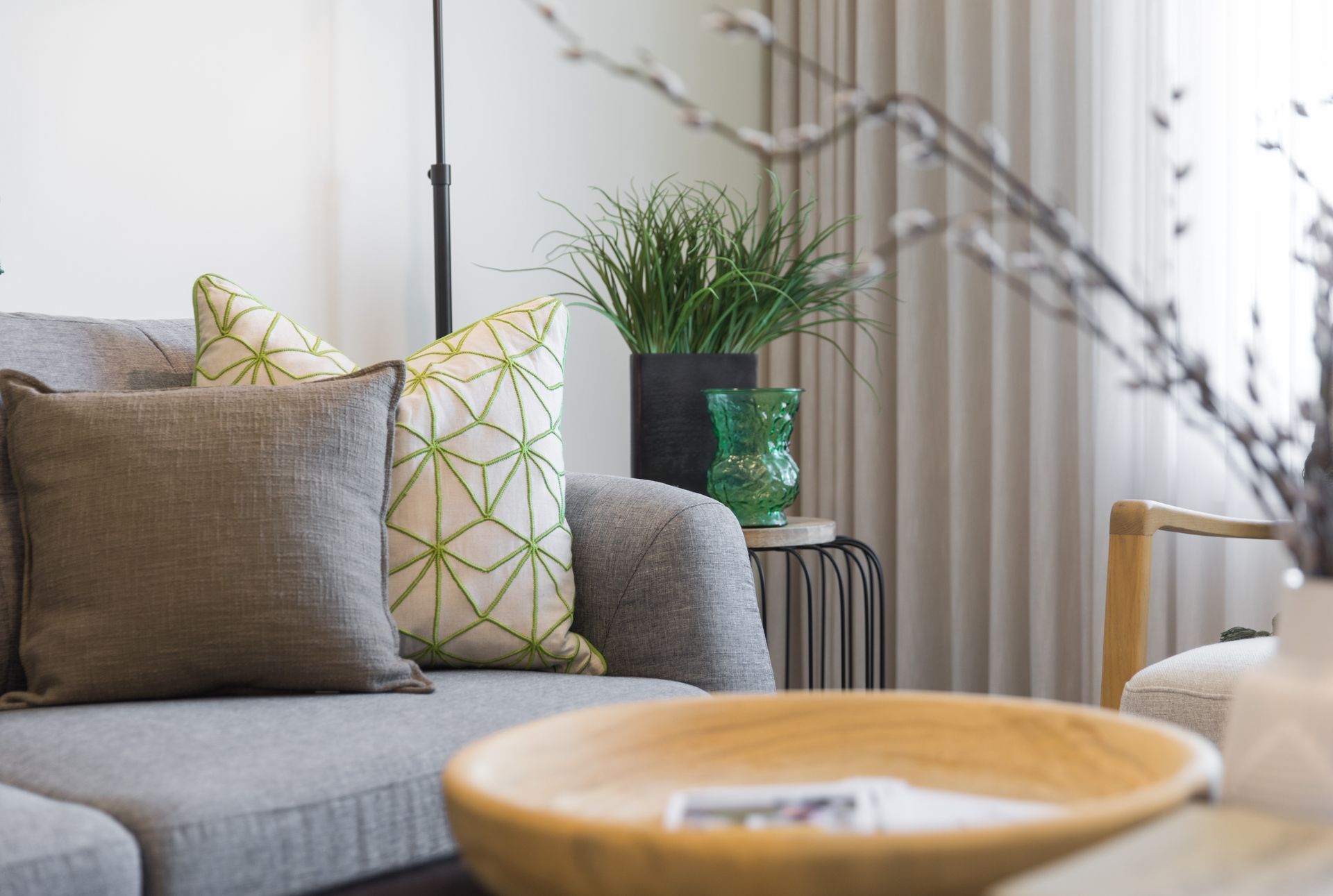 A living room with a couch , chair , table and bowl.