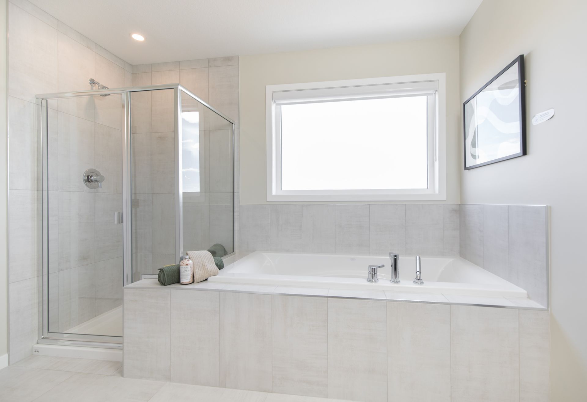 A bathroom with a tub , shower , and window.