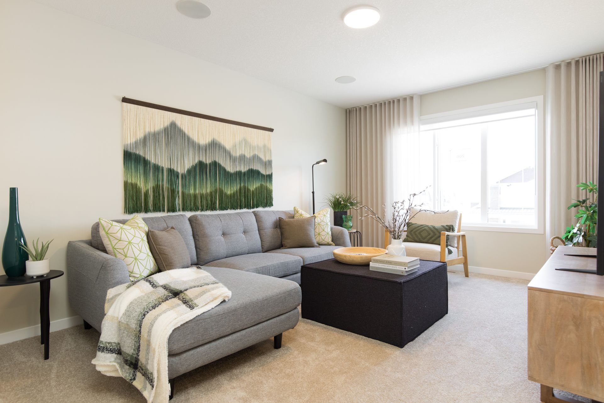 A living room with a couch , coffee table , and television.