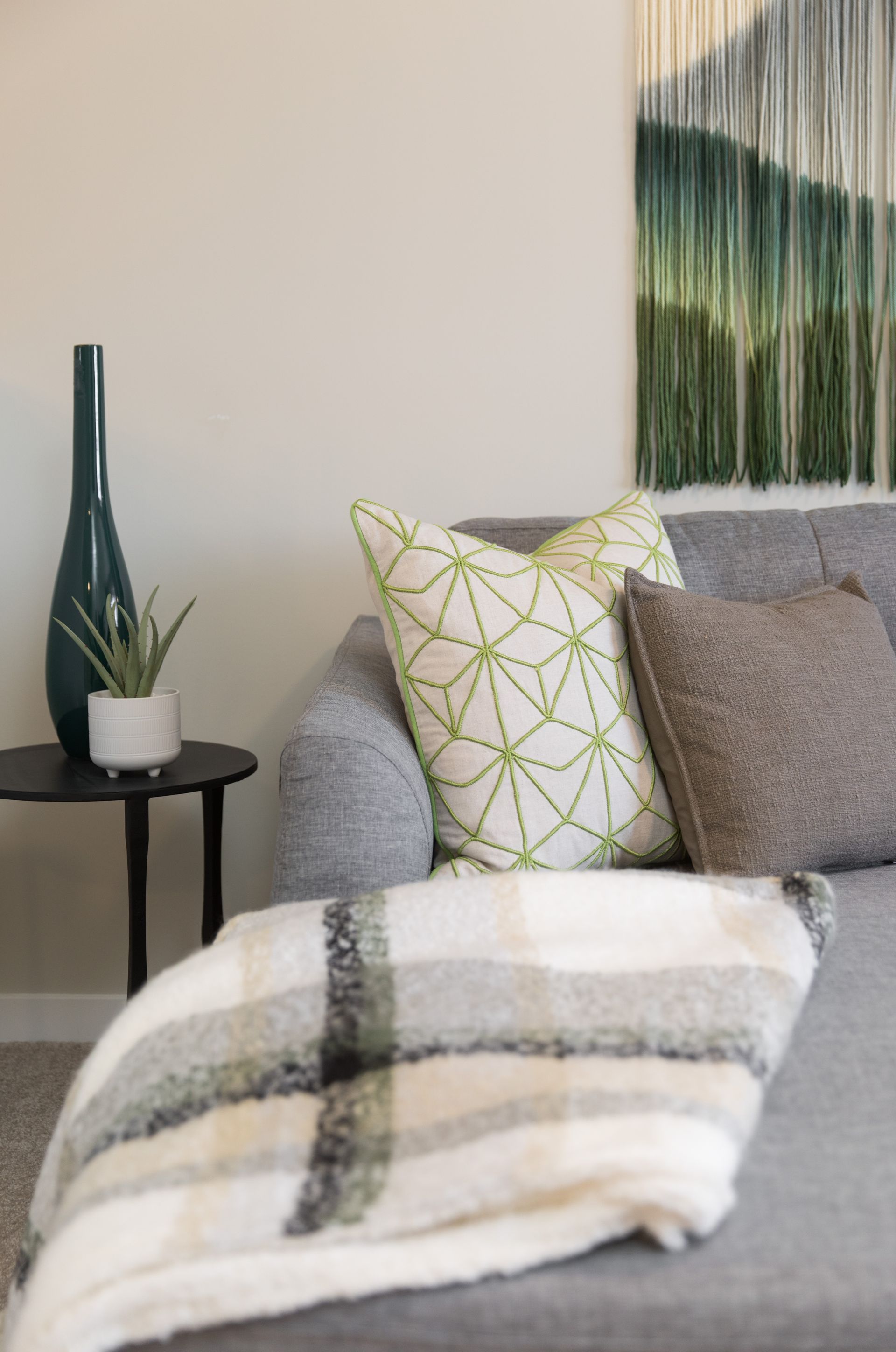 There is a painting on the wall above the couch in the living room.