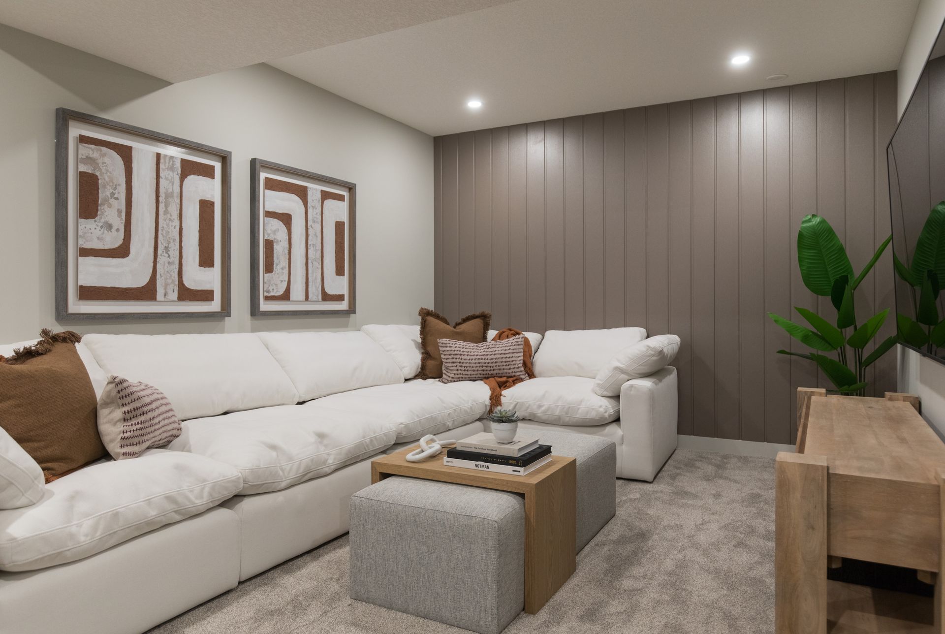 A living room with a large sectional couch and a coffee table.