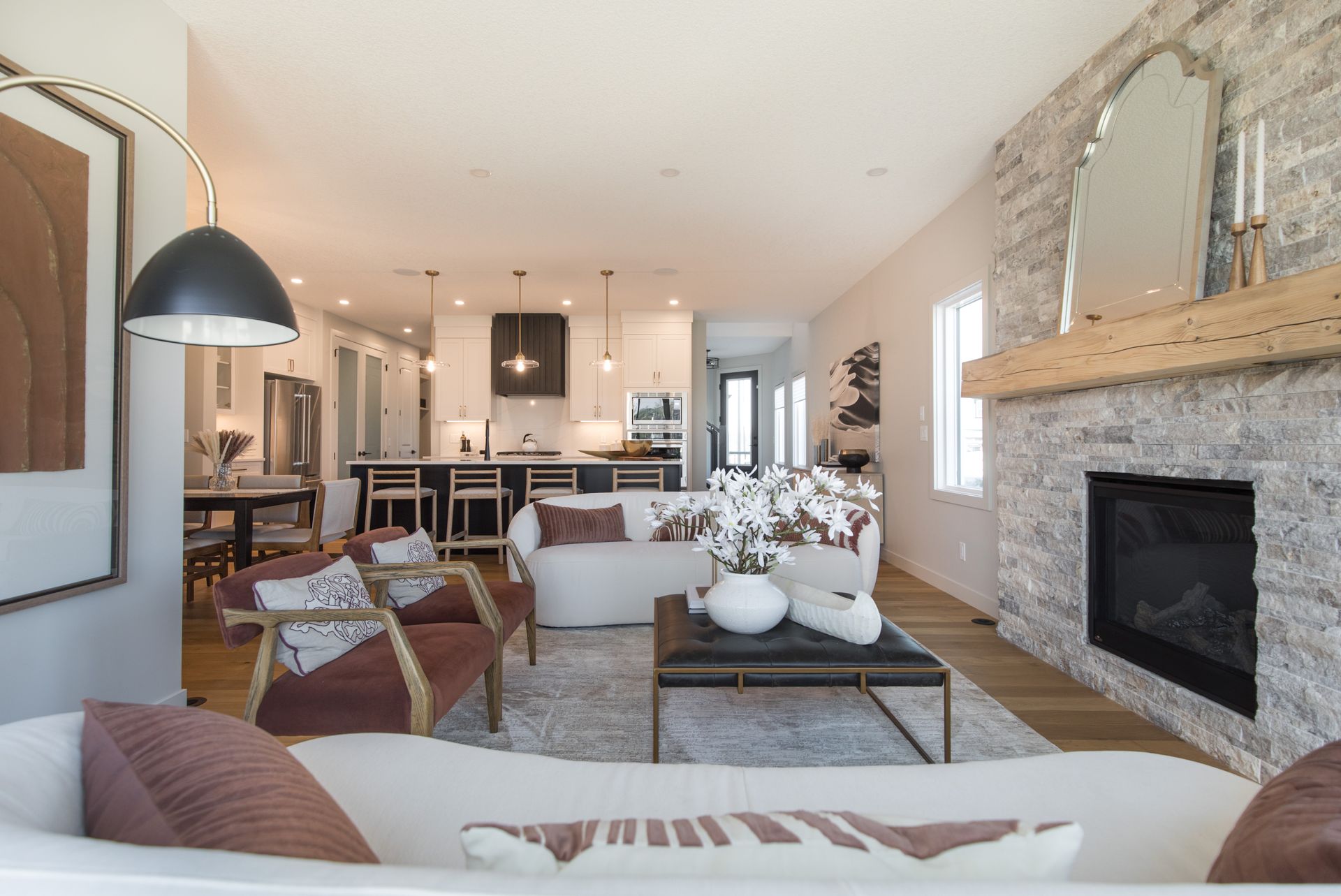 A living room with a couch , chairs , coffee table and fireplace.
