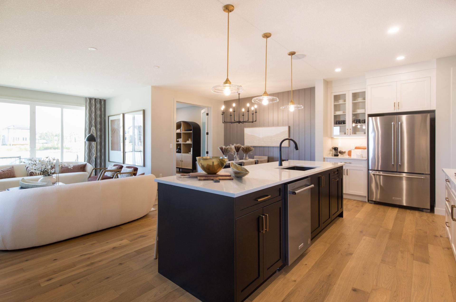 A kitchen with a large island and stainless steel appliances.