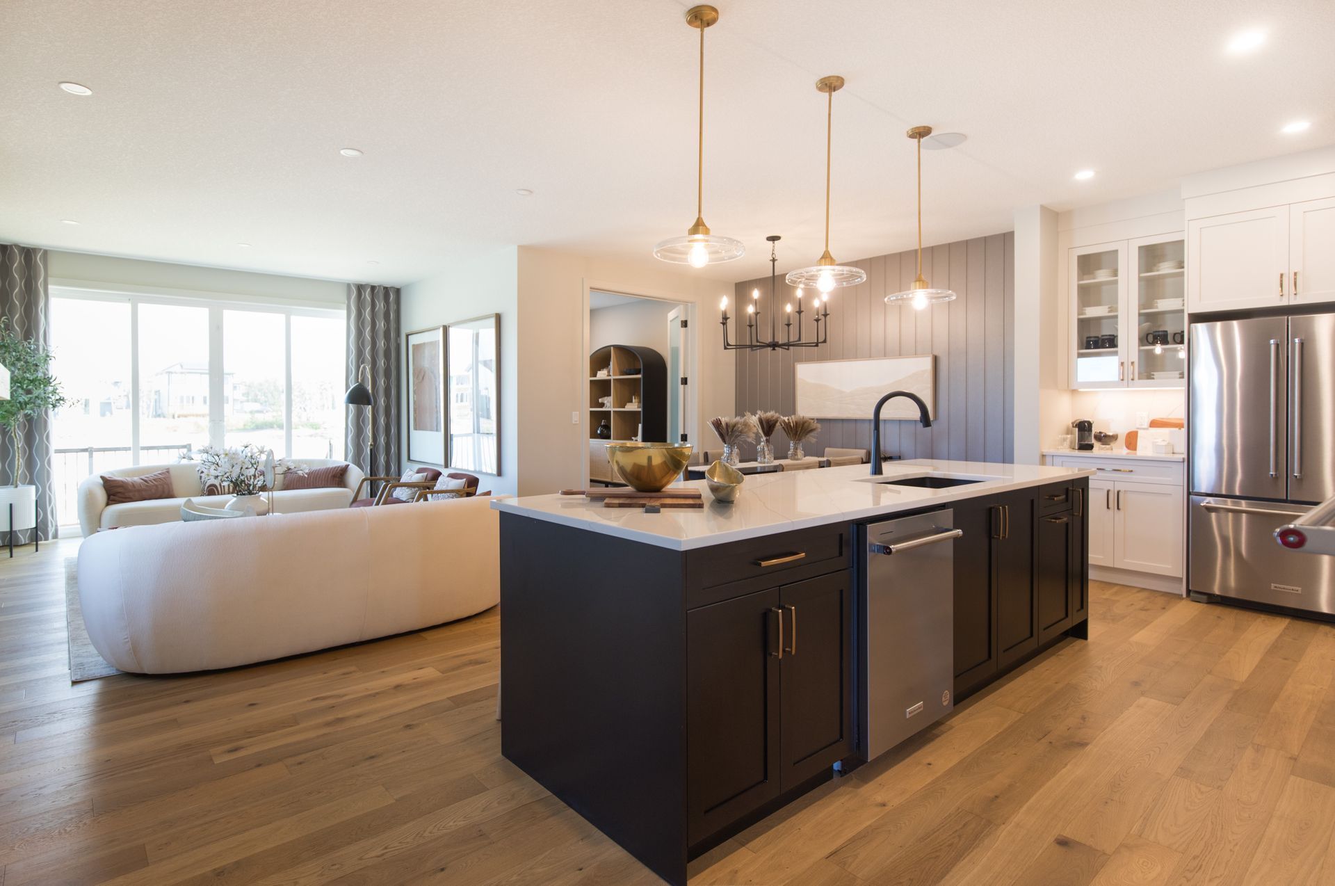 A kitchen with stainless steel appliances and a large island in the middle of the room.