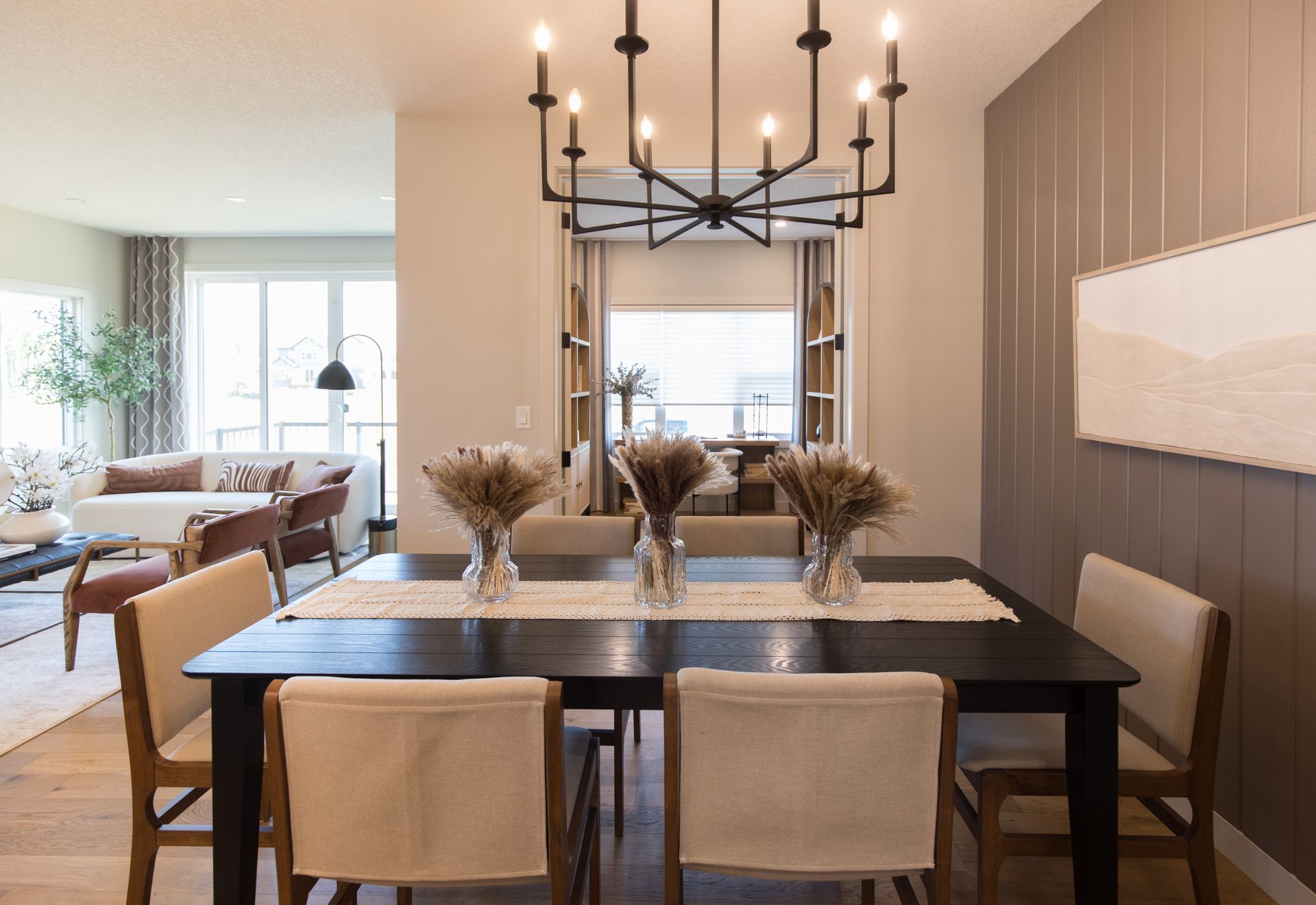 A dining room with a table and chairs and a chandelier.