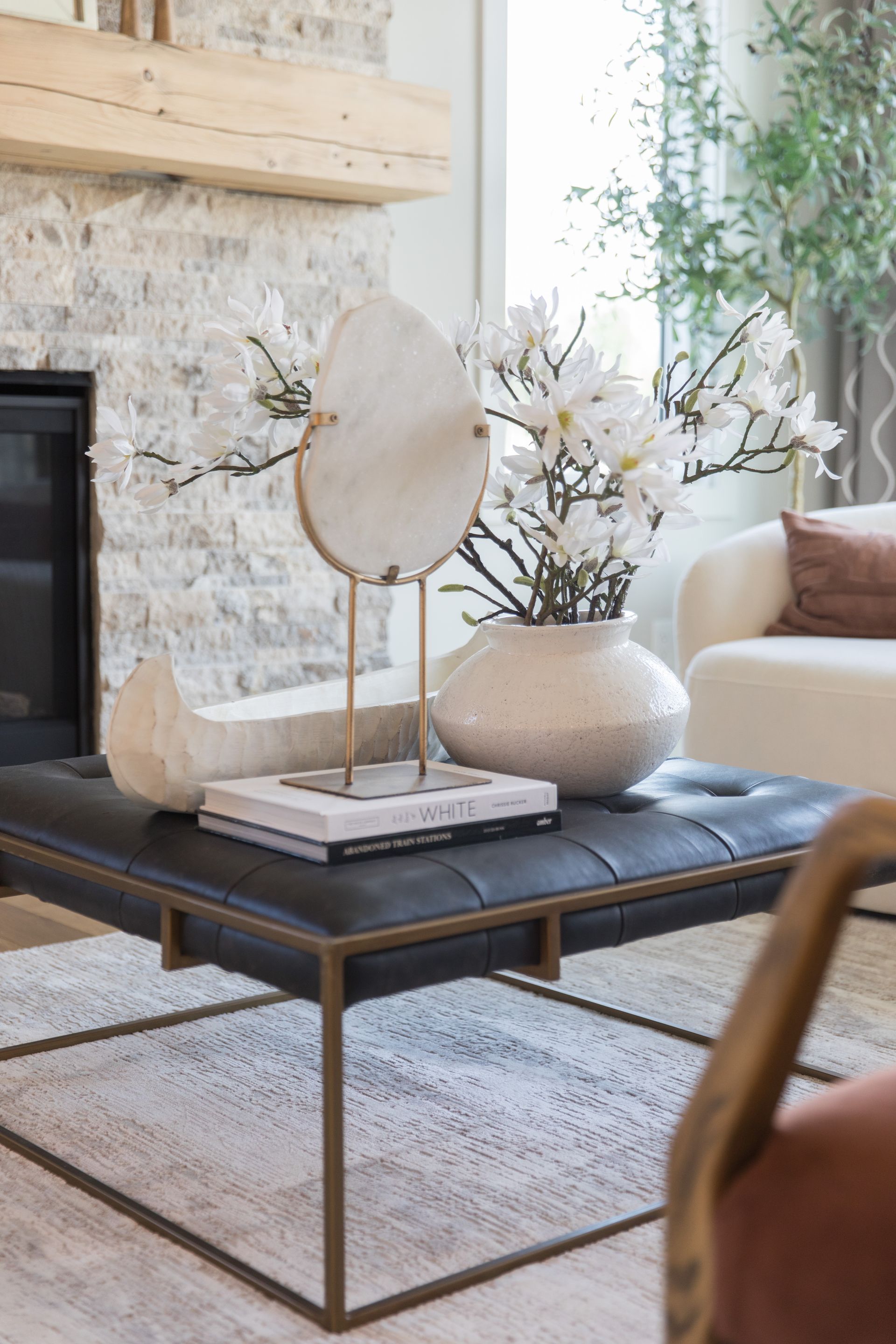 A living room with a coffee table and a fireplace.