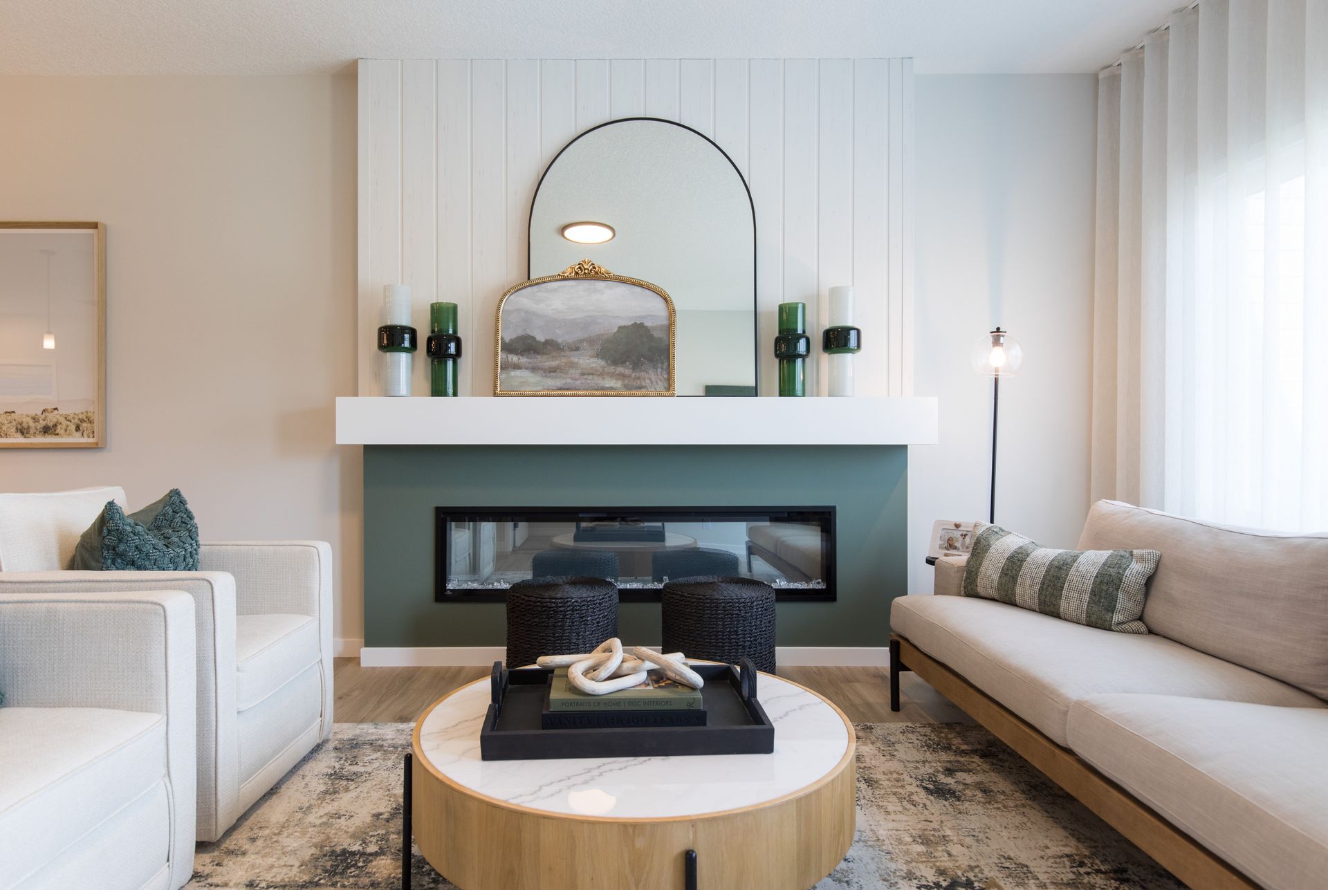 A living room with a fireplace , couch , chair and coffee table.