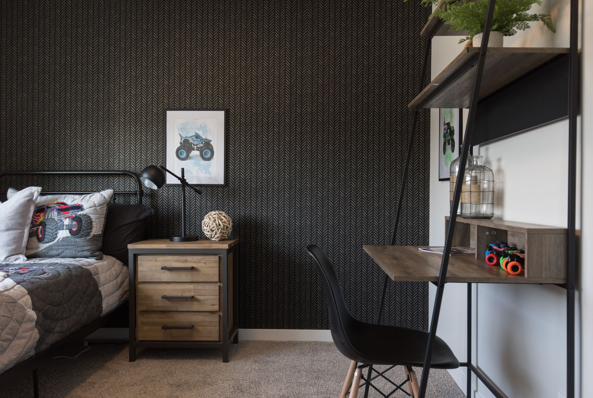 A bedroom with a bed , desk and nightstand.