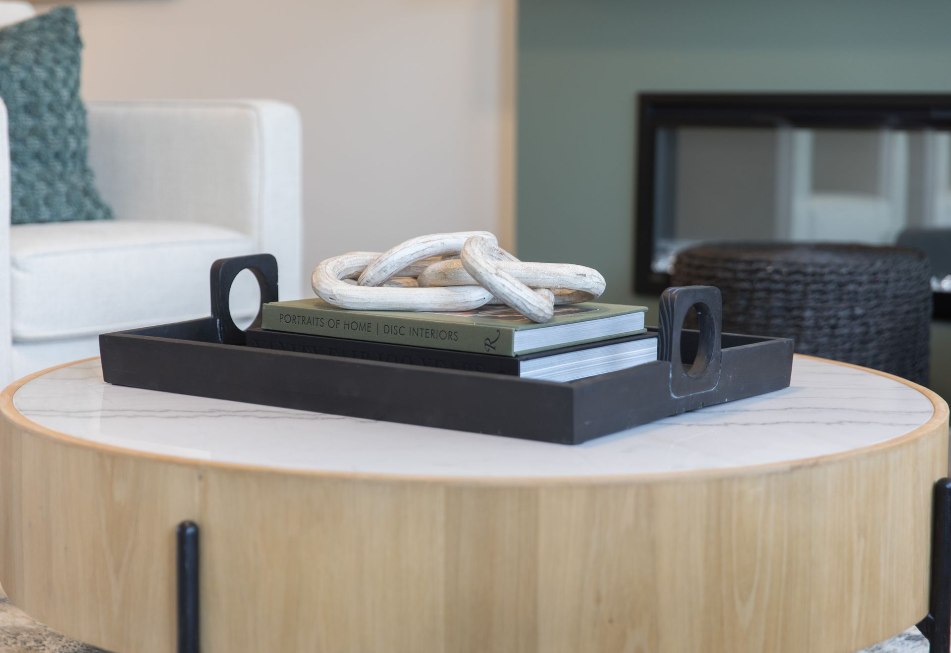 A wooden coffee table with a tray on top of it.
