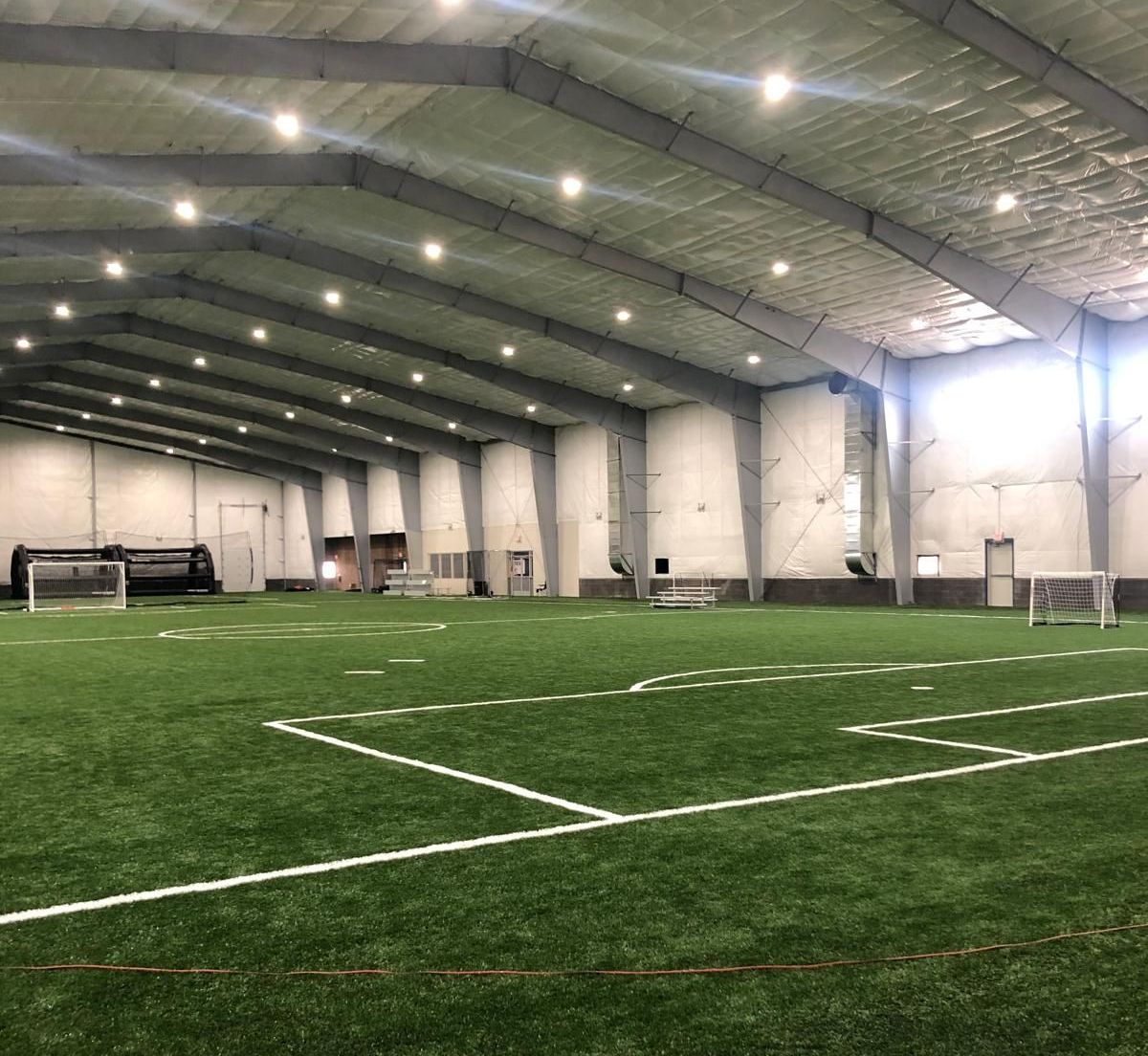 There is a soccer field inside of a building.