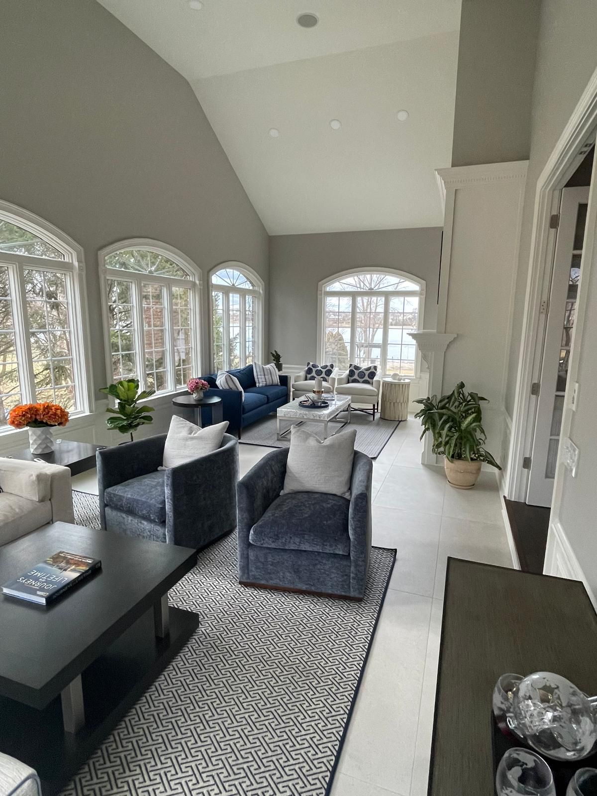 A living room filled with furniture and a vaulted ceiling.