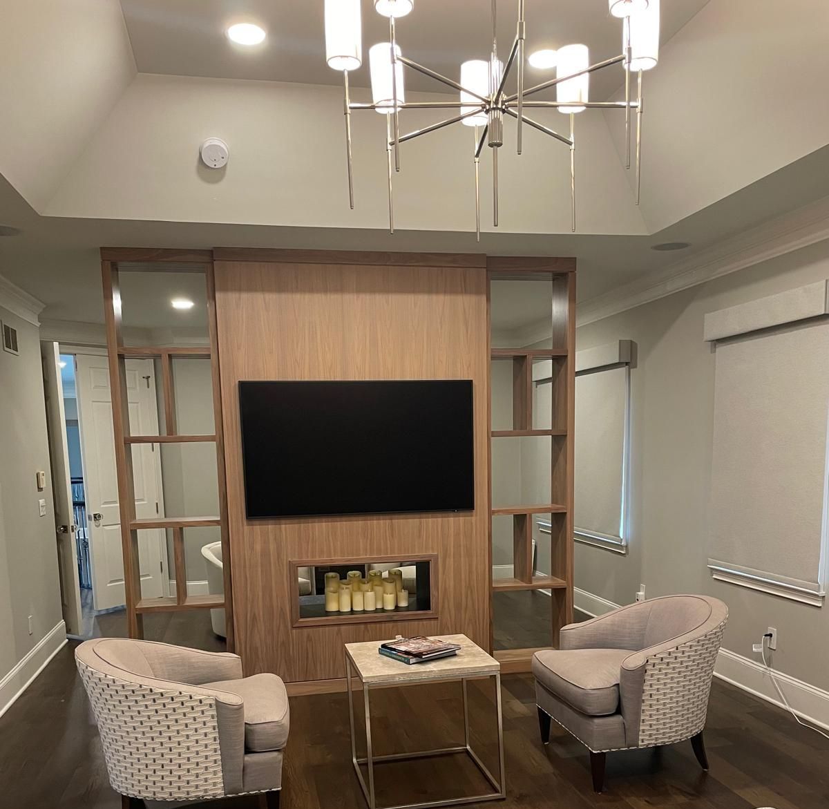 A living room with two chairs and a flat screen tv