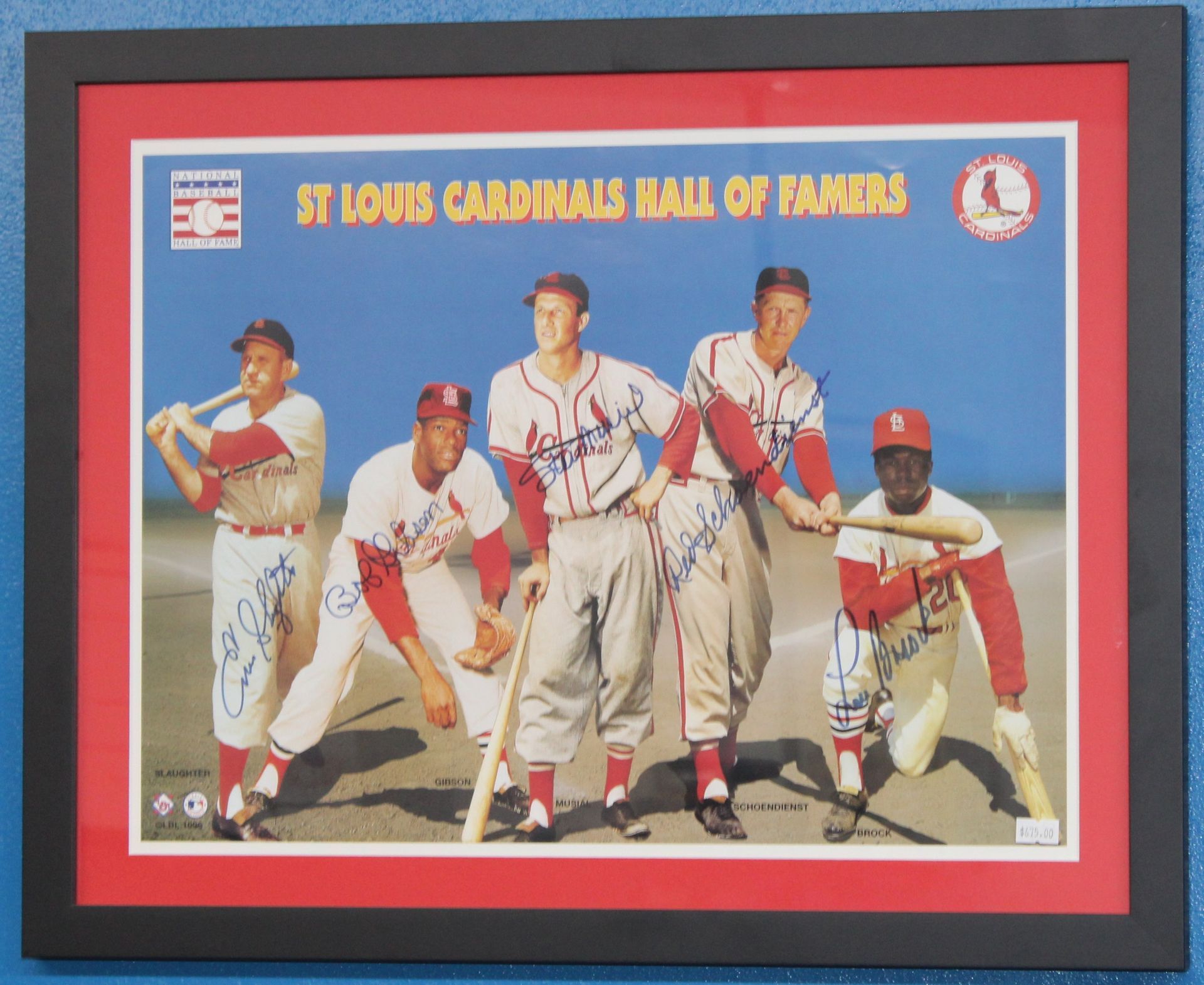 A signed baseball card of barry sanders is in a clear case.