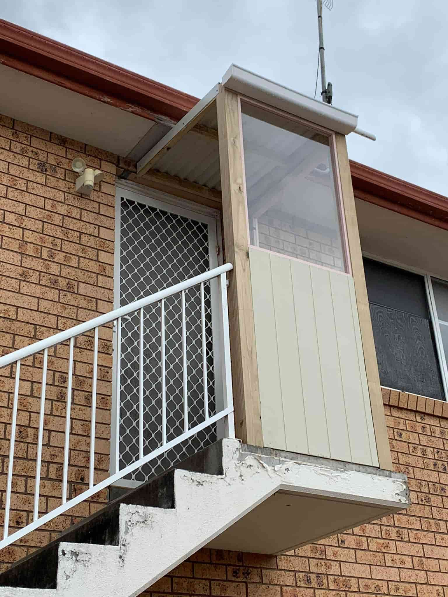 A Closed Door With Stairs — Pride Carpentry & Maintenance In Berkeley Vale, NSW