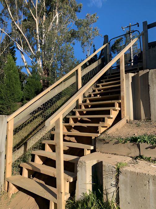 A Wooden Staircase Going Up — Pride Carpentry & Maintenance In Berkeley Vale, NSW