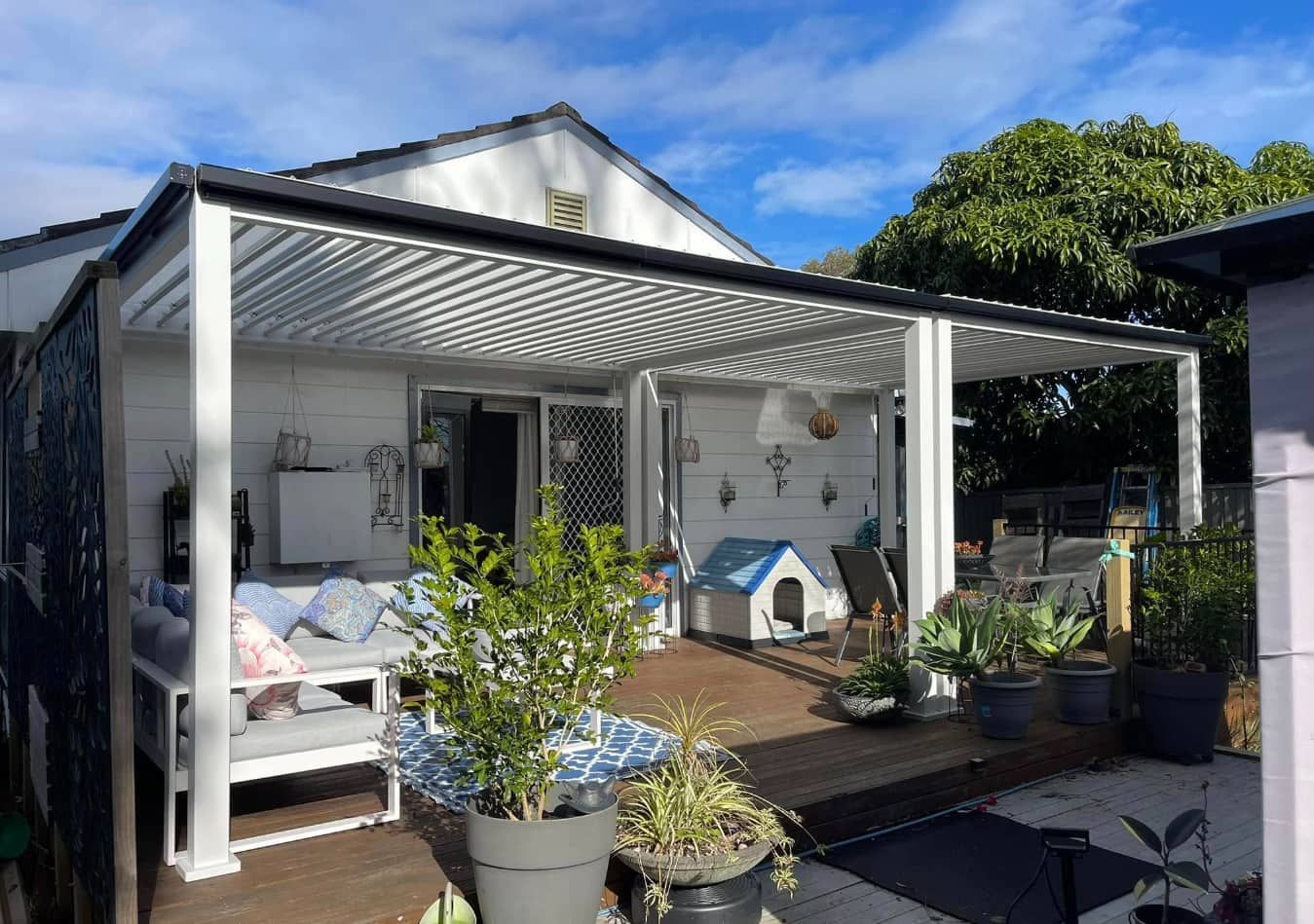 Table Set Under a White Pergola — Pride Carpentry & Maintenance In Central Coast, NSW