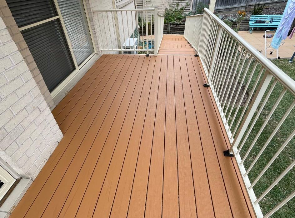 A Deck With a Railing and a White Fence — Pride Carpentry & Maintenance In Berkeley Vale, NSW