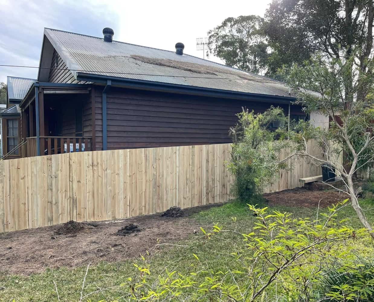 A House is Enclosed by a Fence — Pride Carpentry & Maintenance In Berkeley Vale, NSW