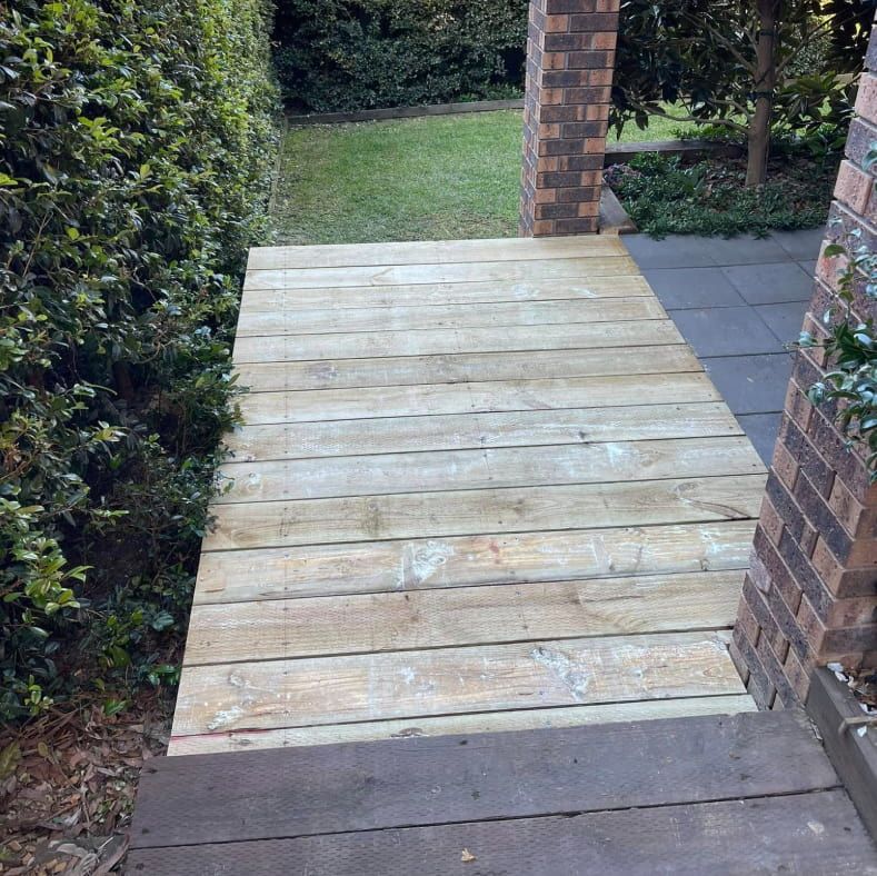 Wooden Deck With a Walkway Leading to a House — Pride Carpentry & Maintenance In Central Coast, NSW