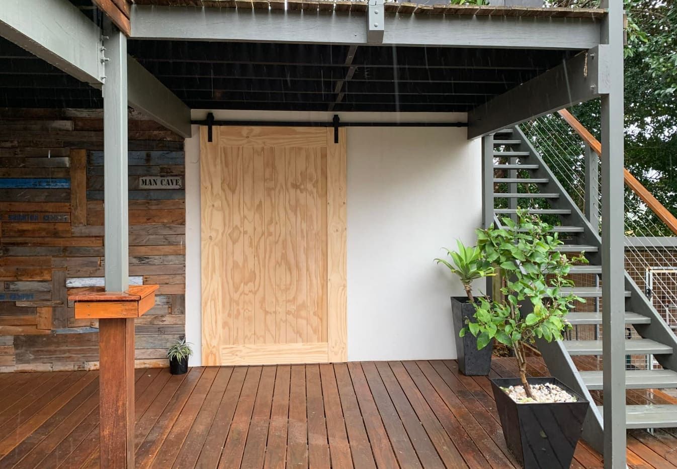 Sliding Wooden Door With Stairs Leading Up to a Deck — Pride Carpentry & Maintenance In Lake Macquarie, NSW