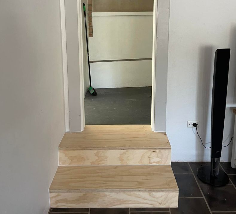 A Staircase Made of Wood With a Door Nearby — Pride Carpentry & Maintenance In Berkeley Vale, NSW
