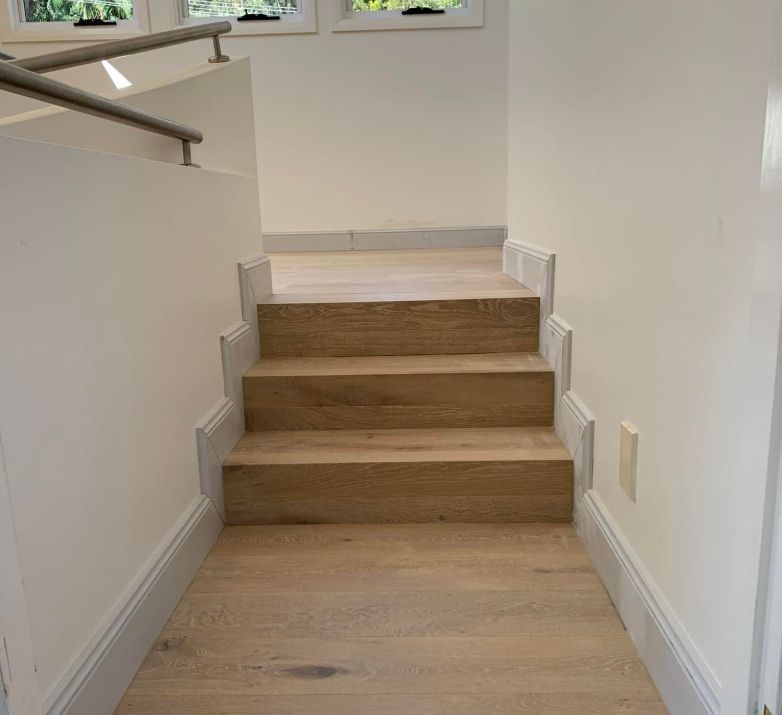 Staircase With Wooden Steps and White Walls — Pride Carpentry & Maintenance In Berkeley Vale, NSW