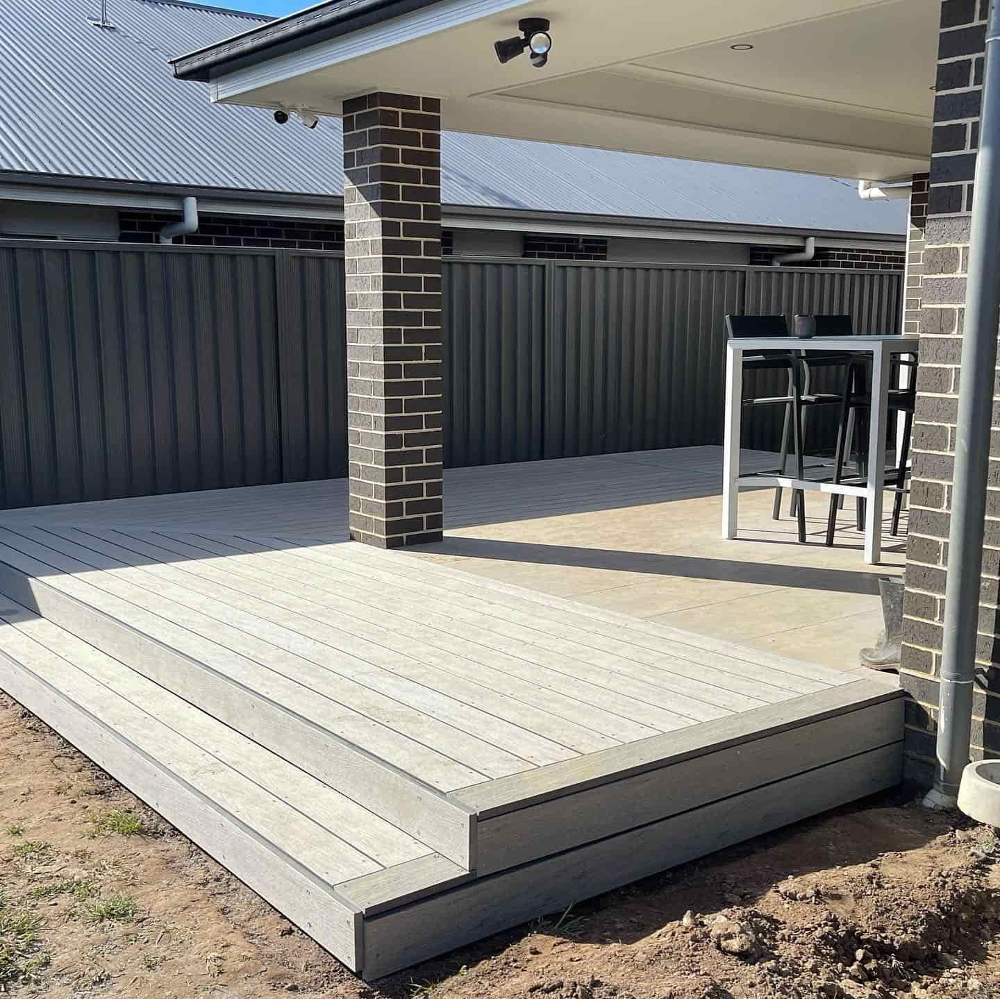 A Deck With a Table and Several Chairs — Pride Carpentry & Maintenance In Berkeley Vale, NSW